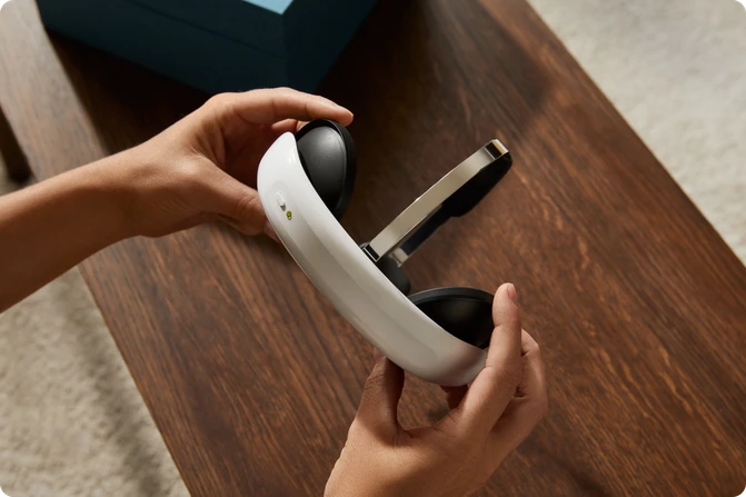 Hands holding the Flow headset